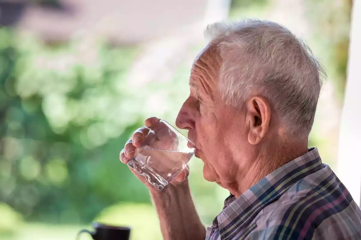Foto de un hombre mayor bebiendo un vaso de agua